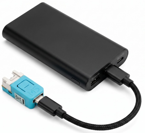 The Water Polo Board, about the size of a stick of gum, plugged into a USB power bank